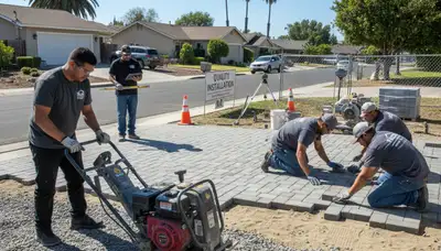 Professional crew installing driveway pavers in San Jose, CA during base prep and leveling process